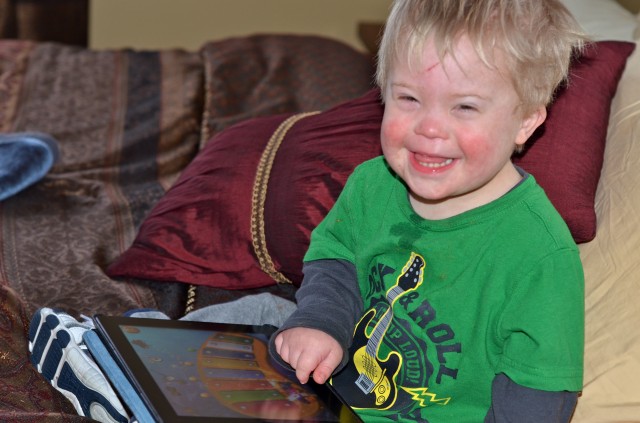 Little boy using an iPad for communication.