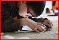Child pouring over iPad