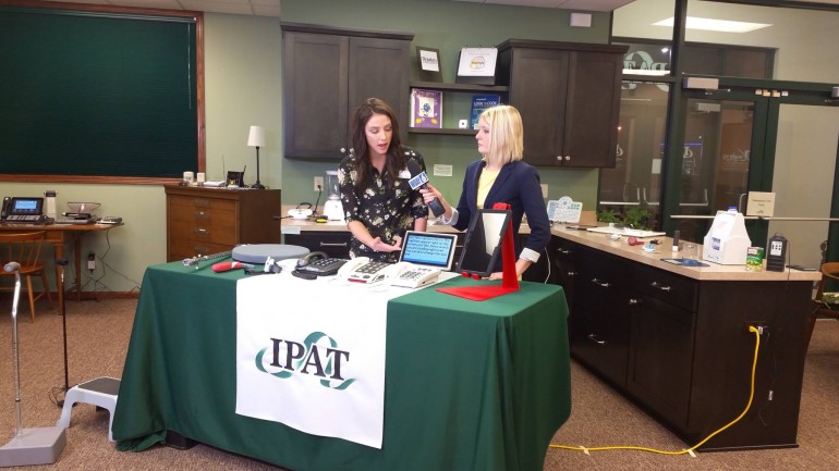 AT Consultant Trish Floyd demonstrates the CapTel phone to anchor Becky Parker.
