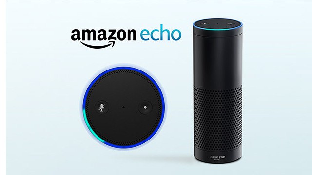 Photo of the Amazon Echo. It is a black cylinder about 1 foot tall and 3 inches in diameter.