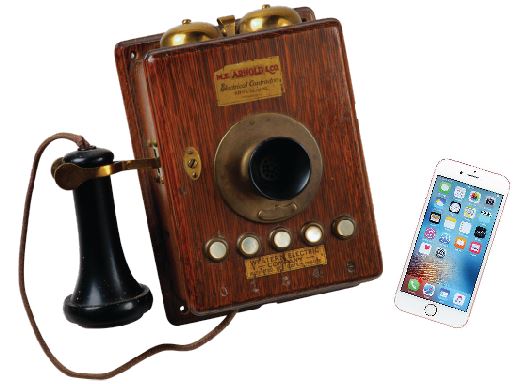 Picture of an old wooden phone and an iPhone.