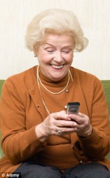 Older woman dialing on a cell phone