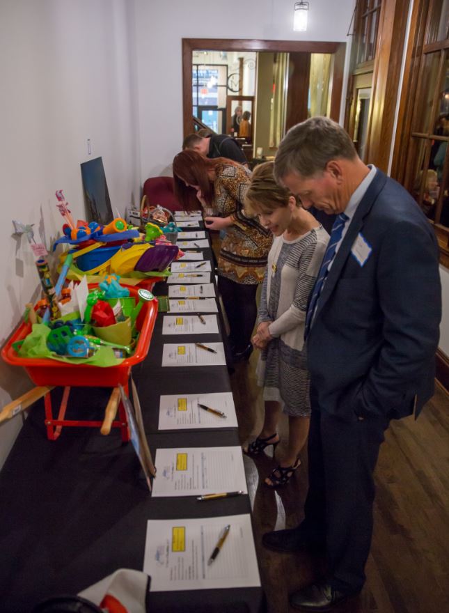 People submitting bids at a silent auction.