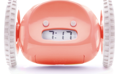 salmon-colored alarm clock with wheels
