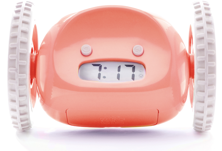 salmon-colored alarm clock with wheels
