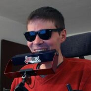 Photo of young many with sunglasses using Jamboxx