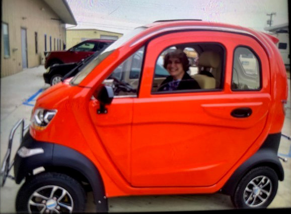 Small Red Scooter Car with Lady Inside