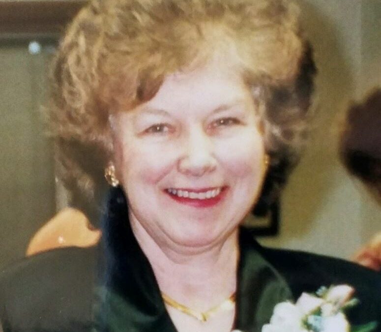 Smiling mother wearing black blouse and white corsage