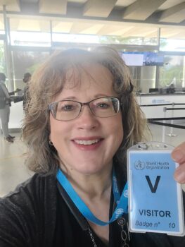 Jeannie Krull at WHO holding up her visitors pass
