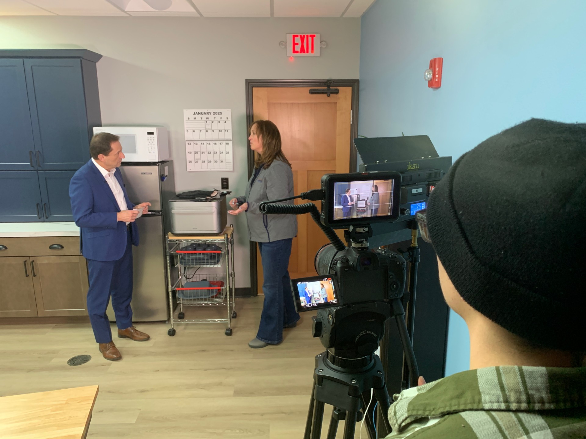 Krista Burman demonstrates the Brava Smart Oven to Wayne Wolff of KFYR-TV.